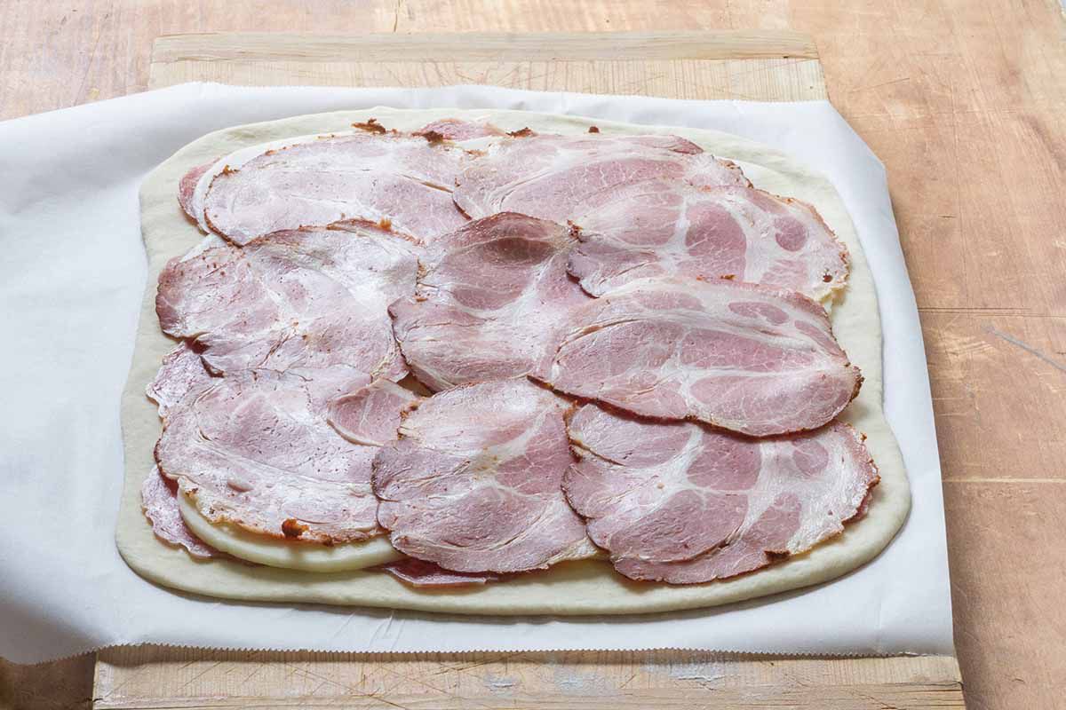 Layer the meat over the pizza dough for the stromboli