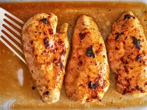 Overhead shot of three marinated and cooked chicken breasts