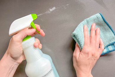 Cleaning solution sprayed onto a counter and wiped down with a towel