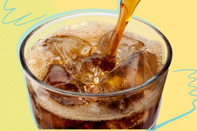Close up of Coke being poured into a glass with ice