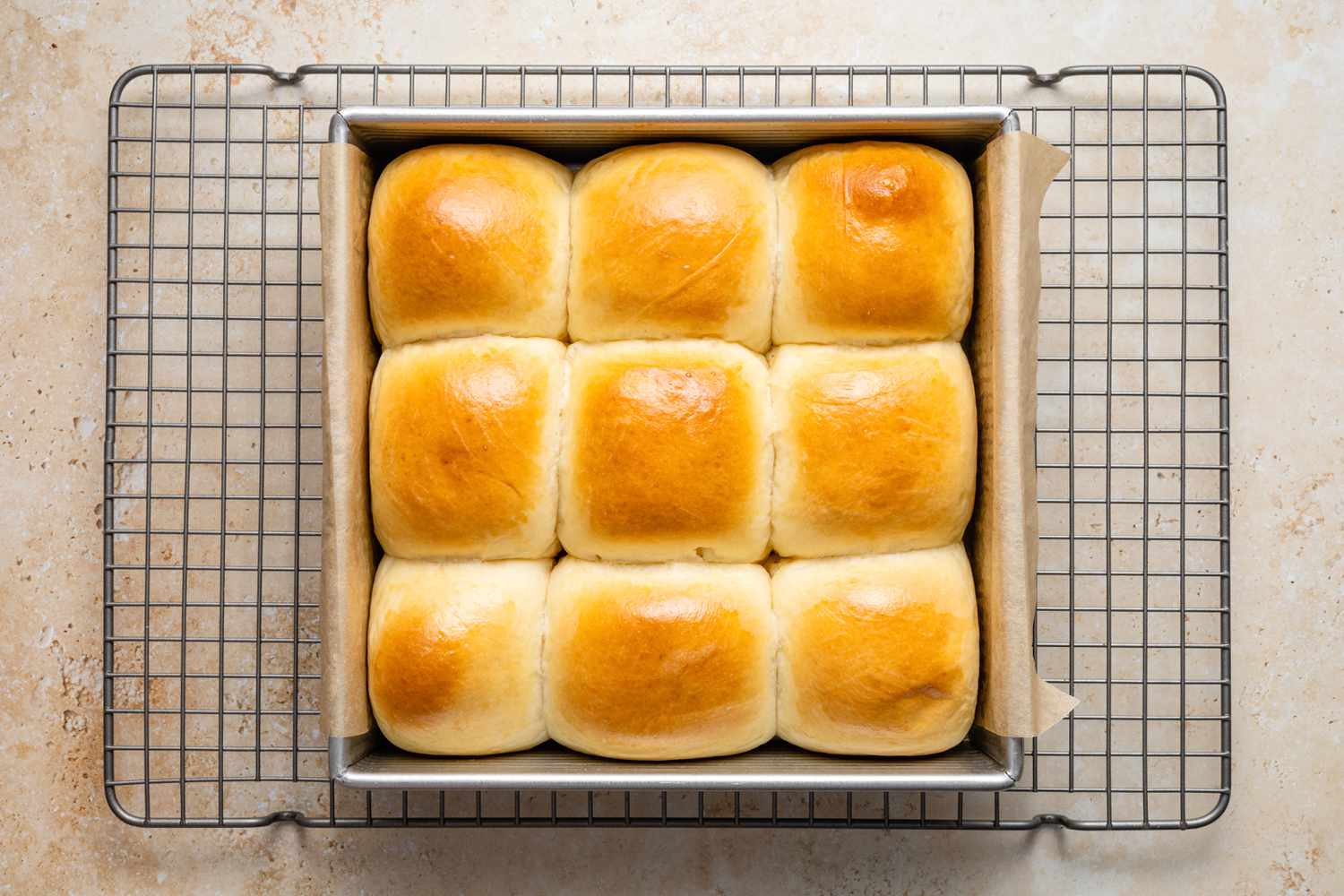 Baked Milk Bread Rolls Resting on a Cooling Rack 