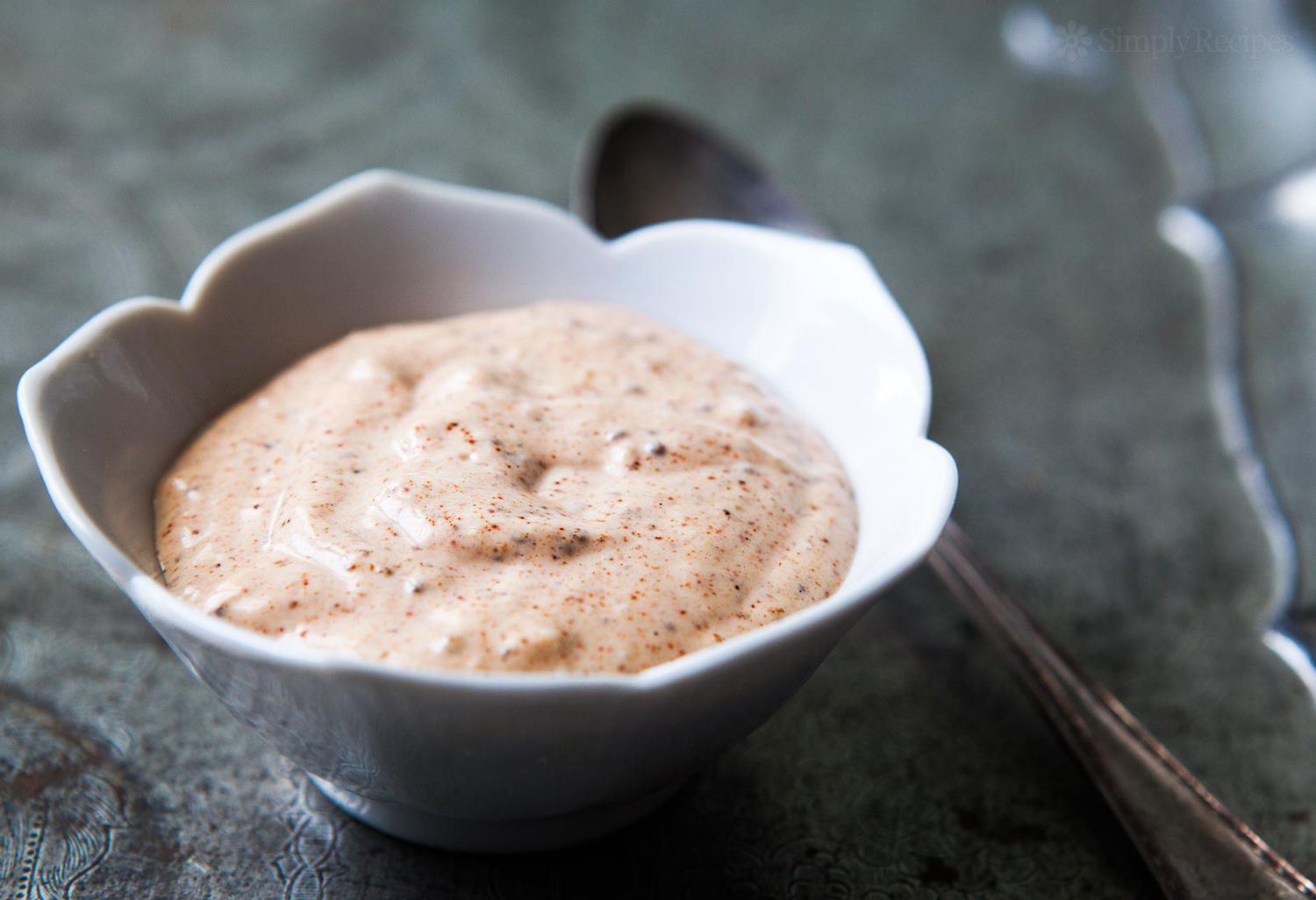 A white bowl with remoulade sauce in it.