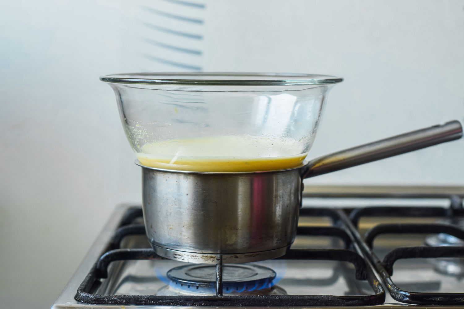 Glass bowl on a pot on the stove for a abaglione recipe.