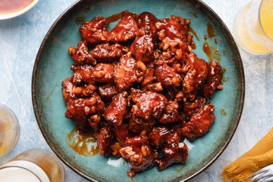 Korean fried chicken on blue platter. 