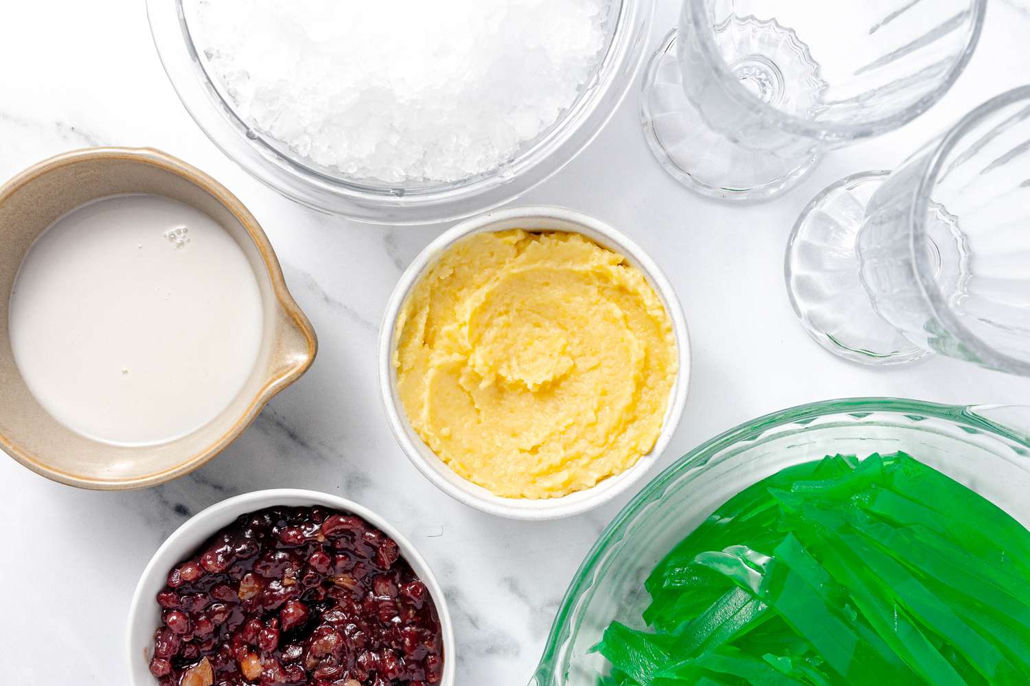 Assembly (L to R): Bowl of Coconut Sauce, Bowl of Crushed Ice, Bowl of Crushed Mung Beans, Bowl of Red Beans Paste, Two Glasses, and Pie Dish With Pandan Jelly for Che Ba Mau 