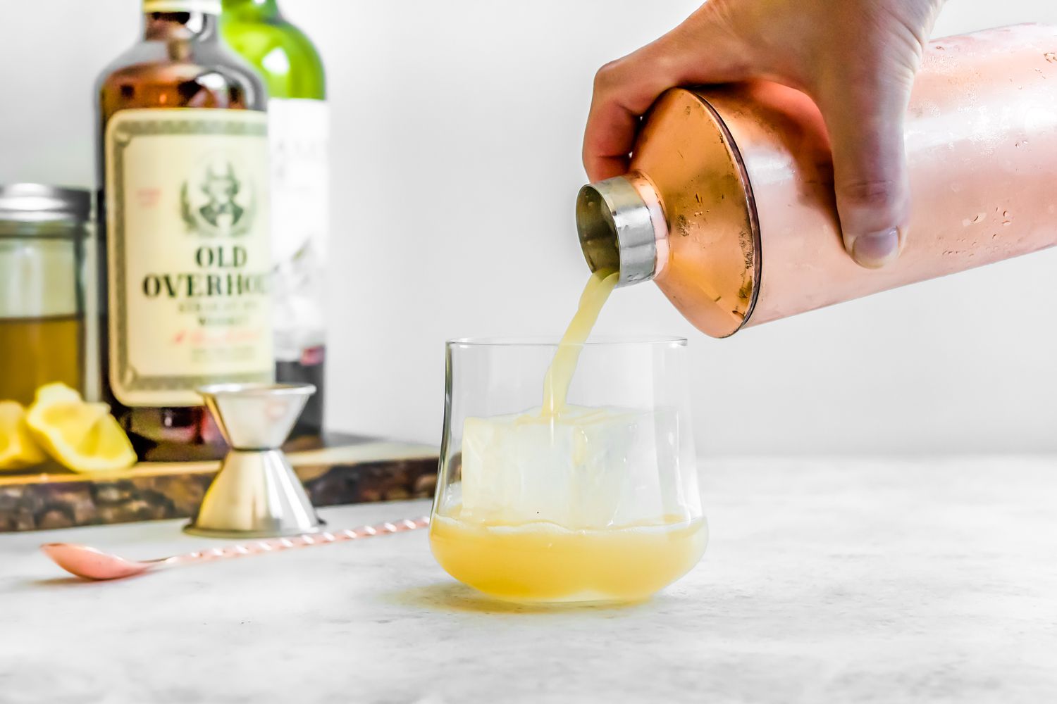 New York Sour Cocktail Poured into a Glass with Ice from a Cocktail Shaker 