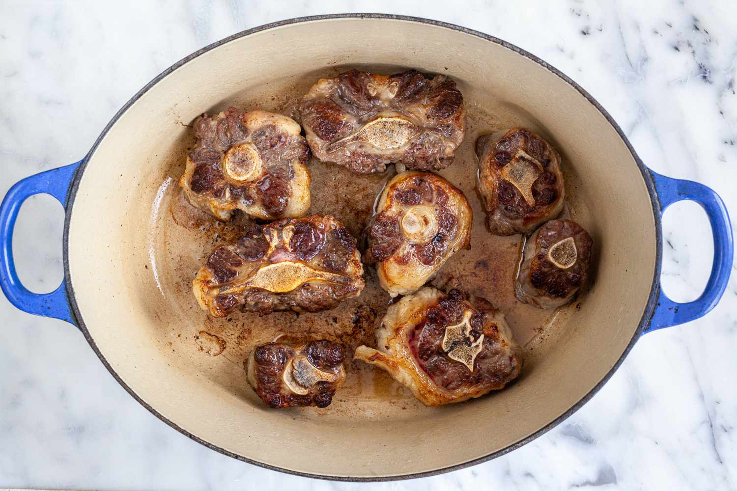 Searing oxtails in a dutch oven to show how to cook oxtails.
