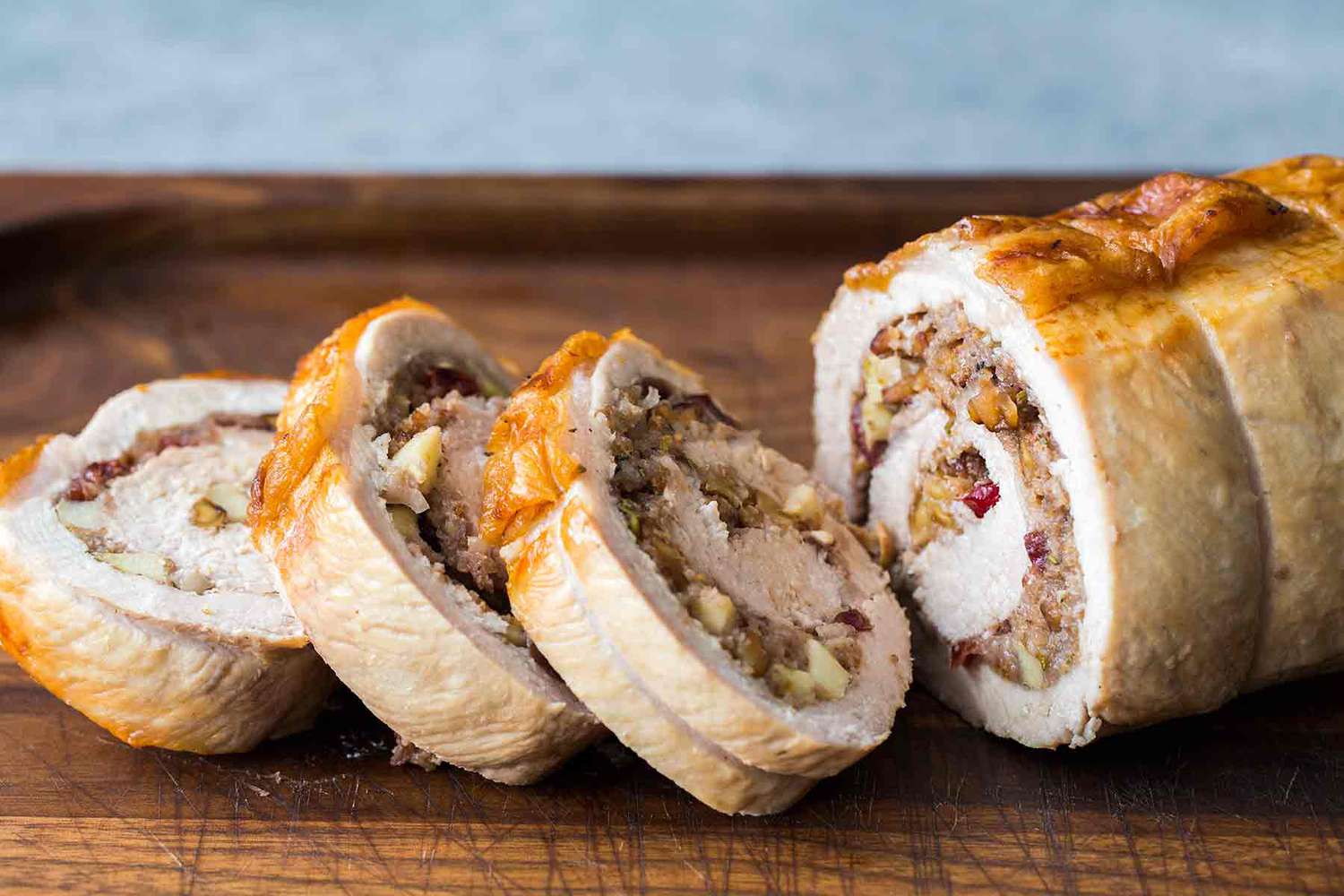 Cranberry Apple Stuffed Pork Loin sliced on a cutting board