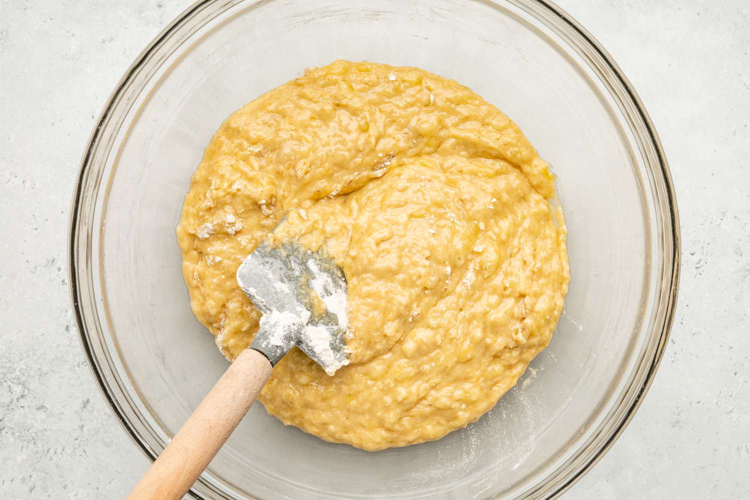Dry Ingredients Mixed Into Mashed Bananas Mixture Using a Spatula for Chocolate Chip Banana Bread Coffee Cake Recipe