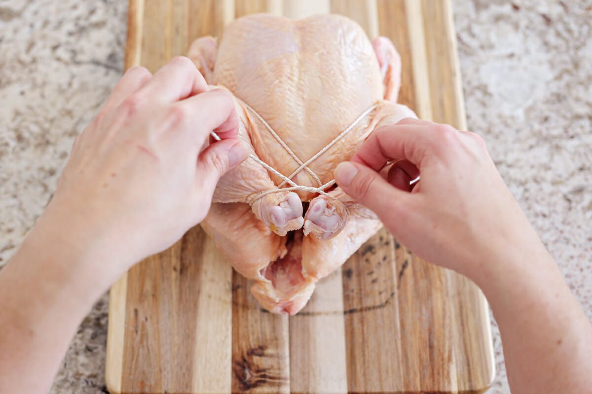 Trussing a chicken for roasting tie a knot