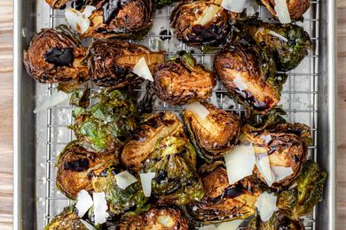 On a a Cooling Rack over a Baking Pan, Deep Fried Brussels Sprouts Topped with Shaved Parmesan and Balsamic Vinegar 