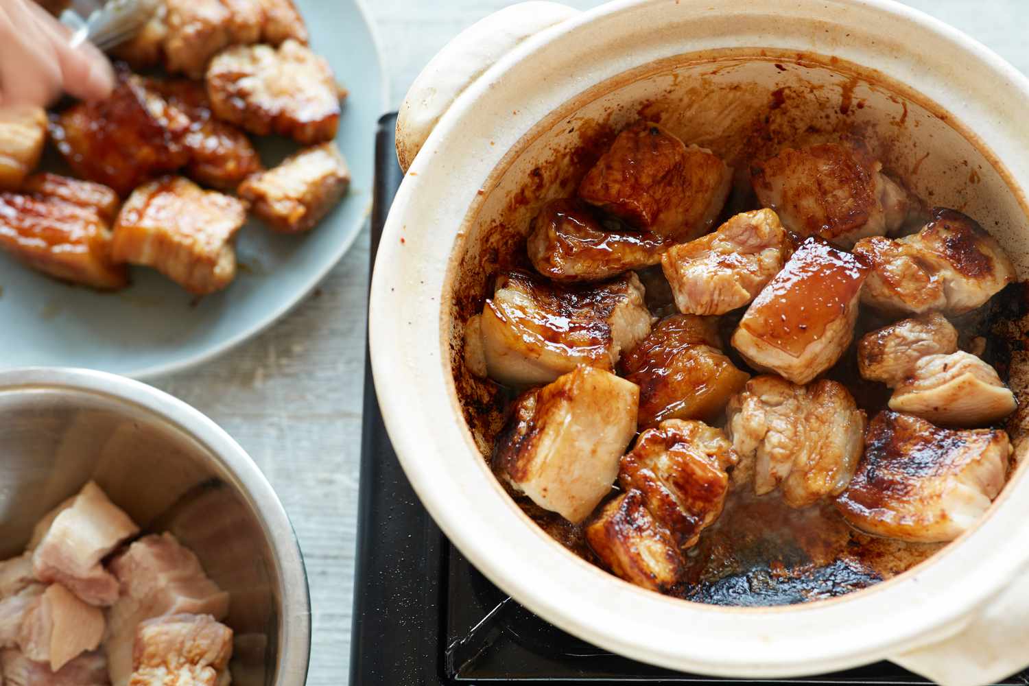 Searing pork belly to make Vietnamese braised pork belly and eggs 