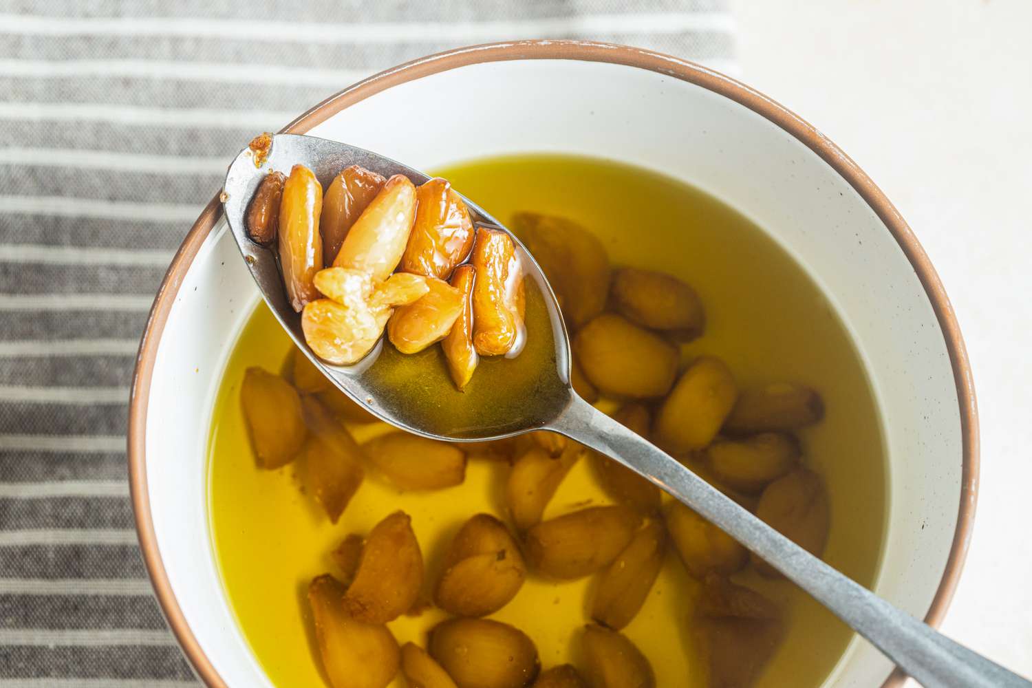 Garlic Confit on Spoon with More in Bowl