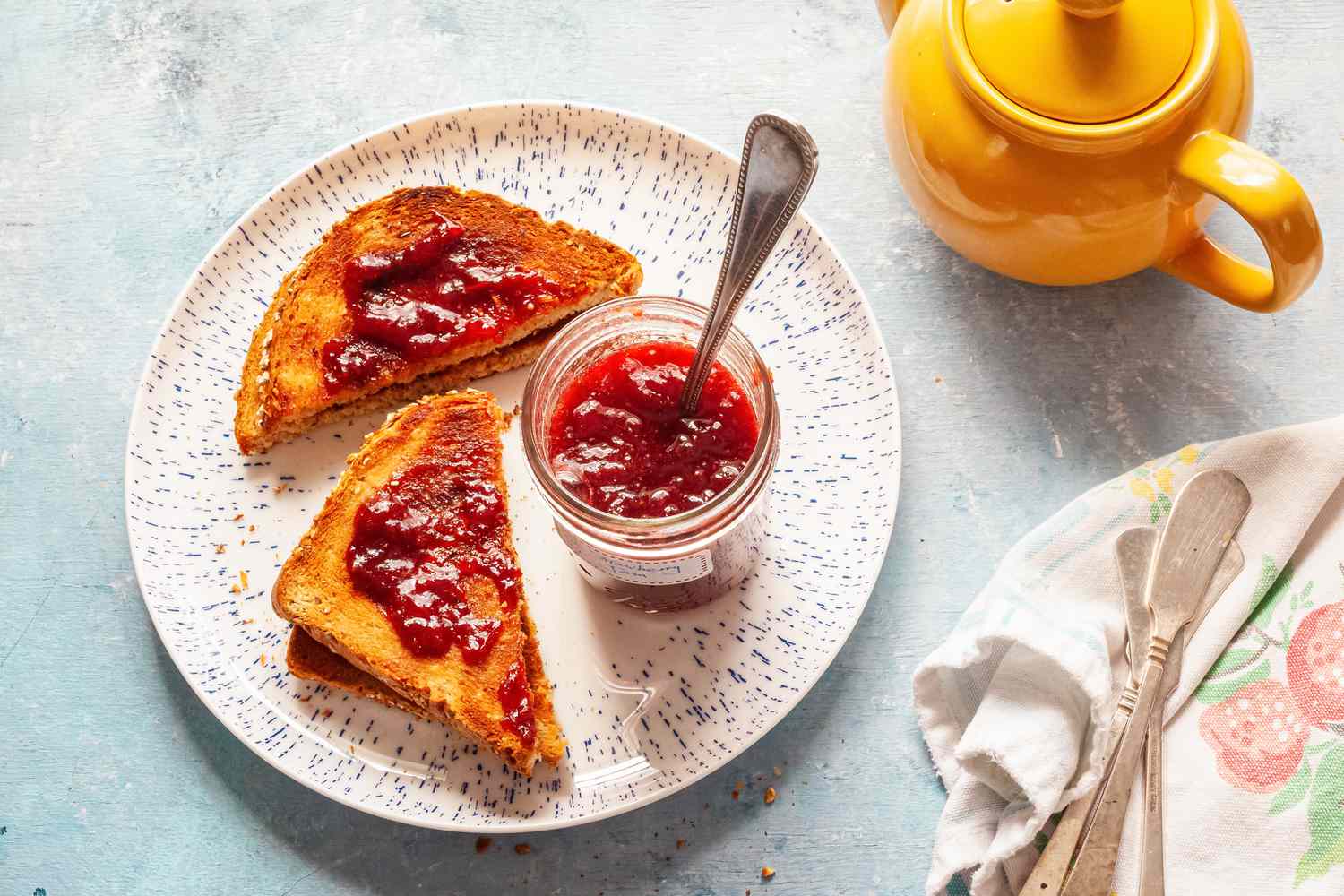 Strawberry Jam for Canning, Served with Toast on a Plate and Tea Pot on Table