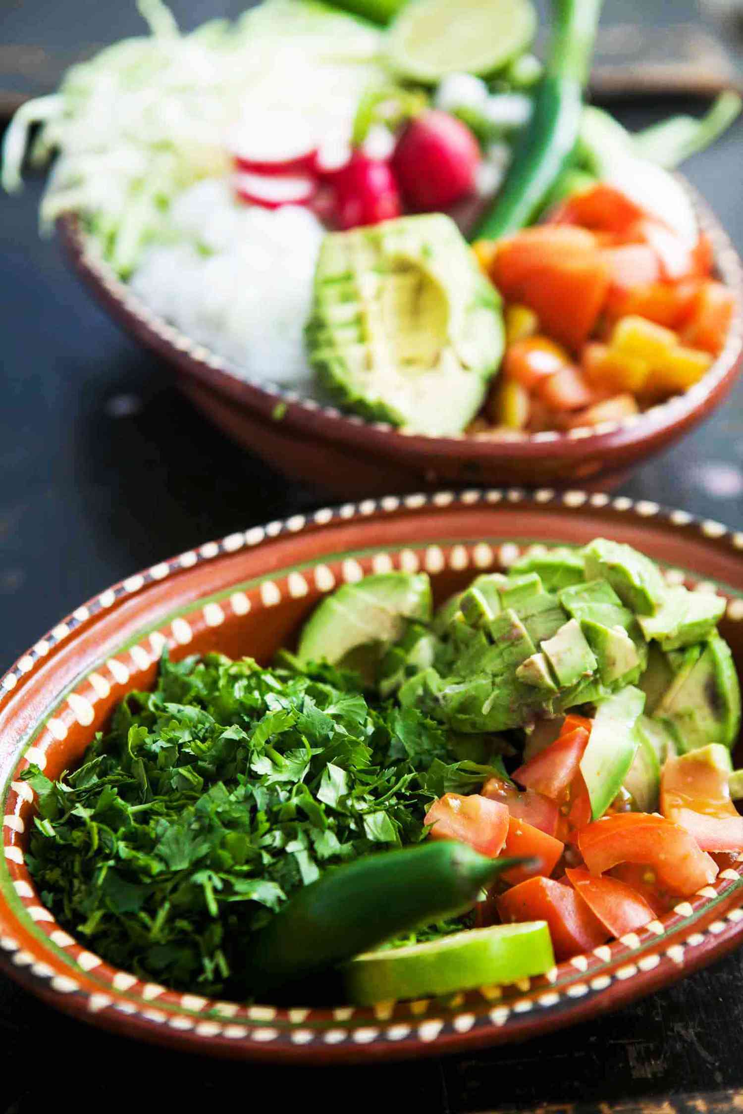 Toppings for Posole Rojo in brown bowls