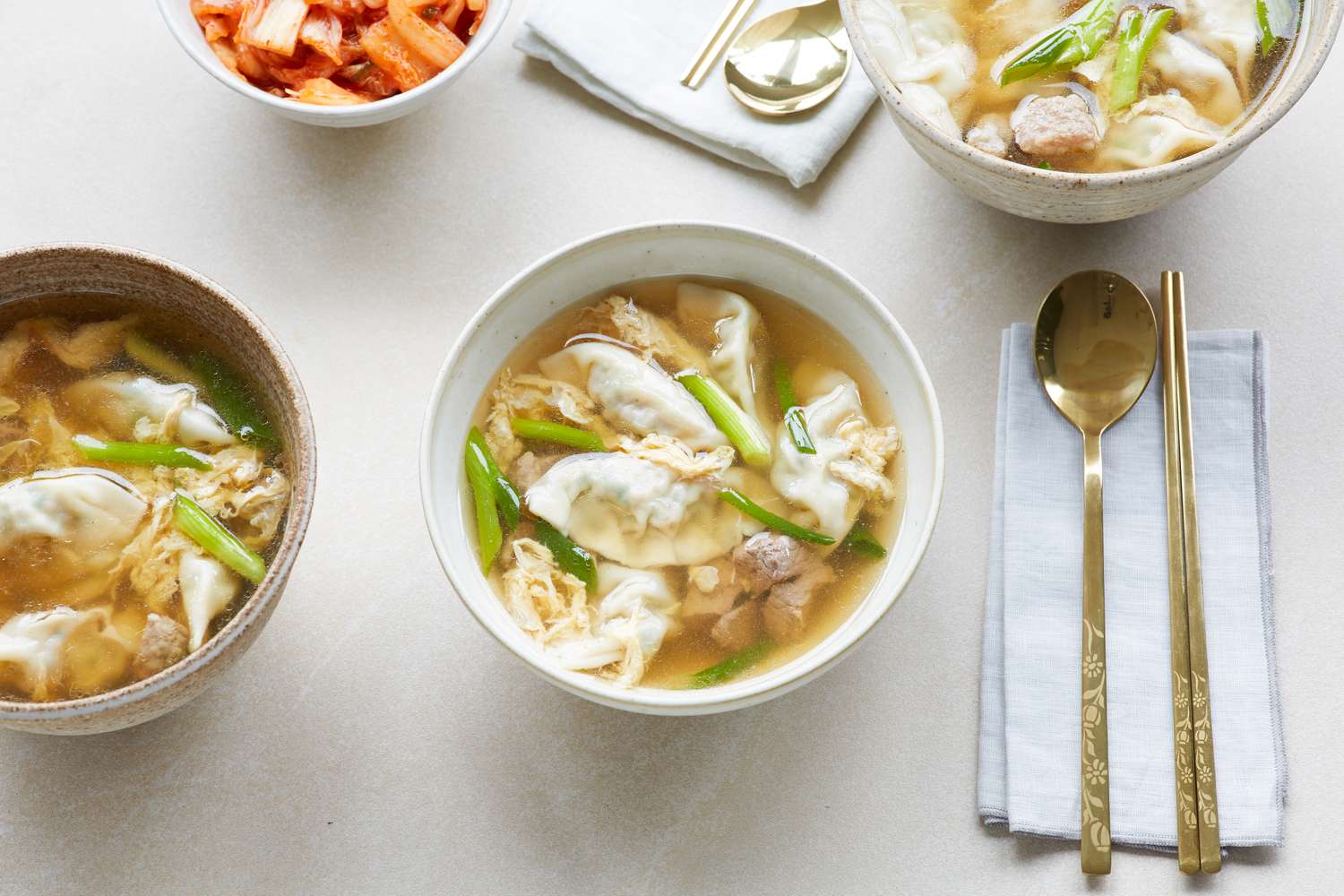 Overhead view of a bowl of beef soup with dumplings.