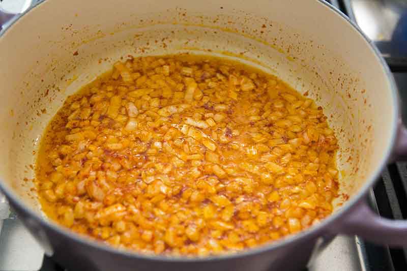 onions and tomato paste cooking in a pan