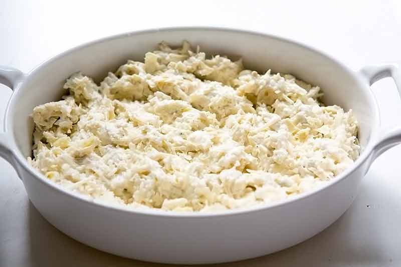 Raw Artichoke Ingredients In Large White Baking Dish 