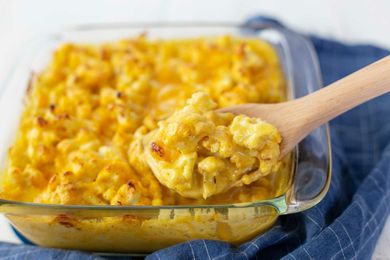 Scooping Easy Cauliflower Bake out of a glass casserole dish.