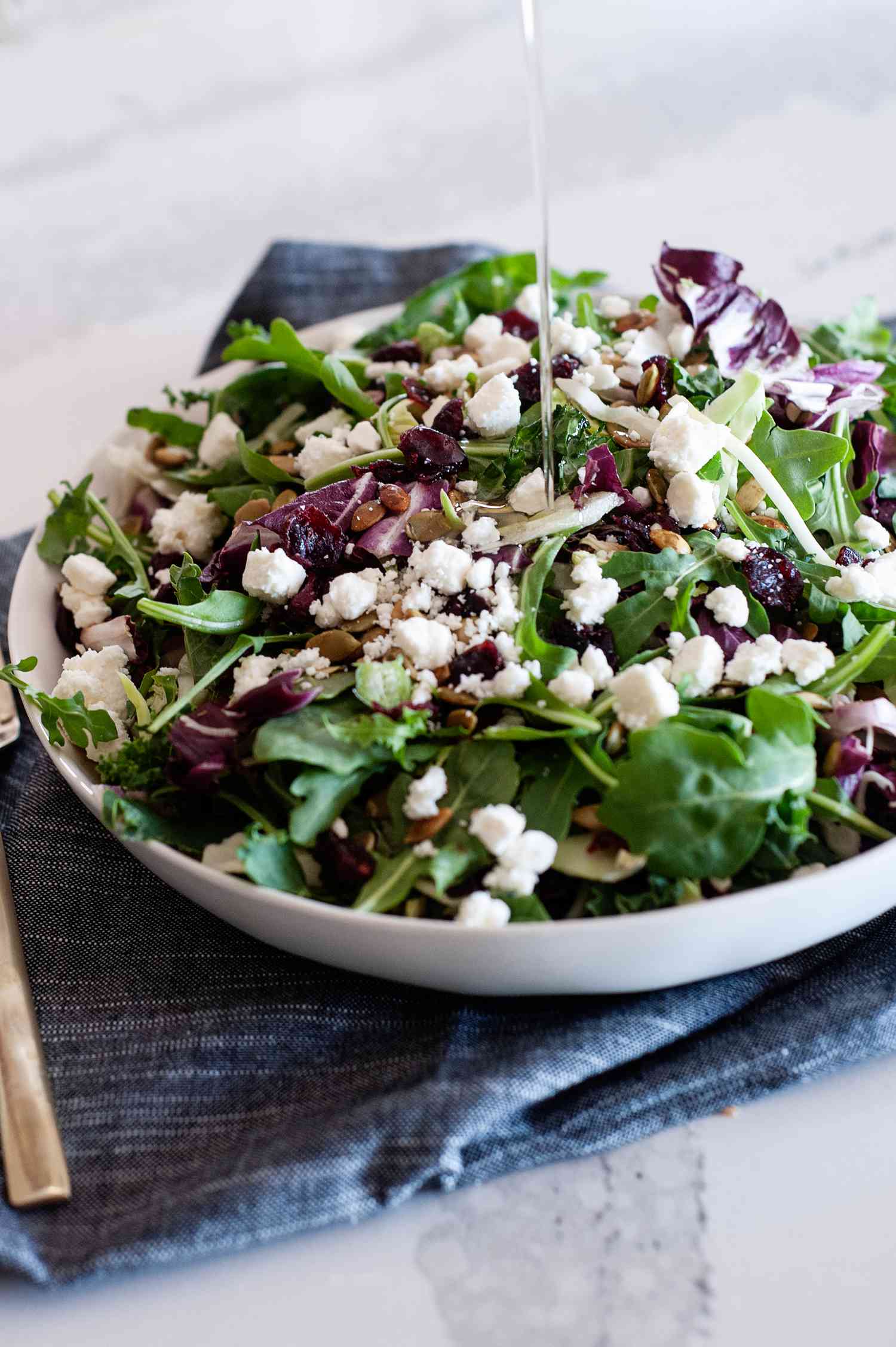 Drizzing walnut oil over a salad