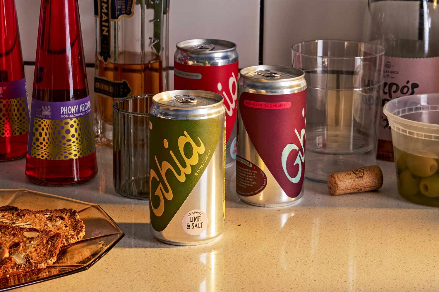 A kitchen countertop with cans of Ghia, Phony Negroni