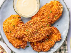 pretzel chicken on a plate with a bowl of sweet dijon mayo 