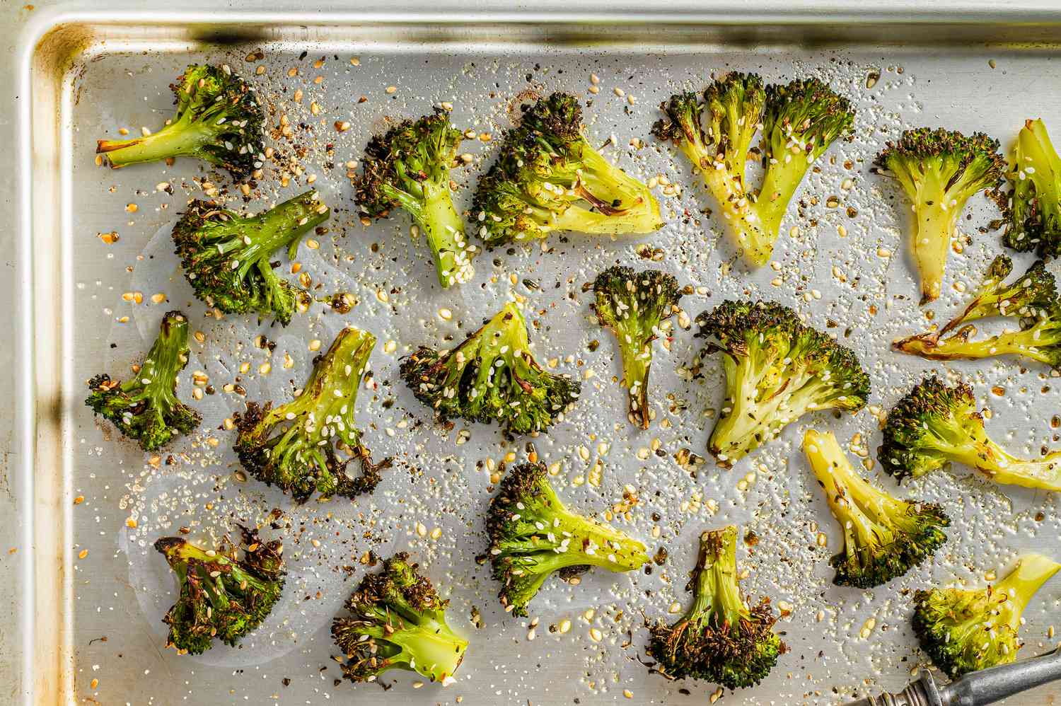 roasted, seasoned broccoli florets on a sheet pan