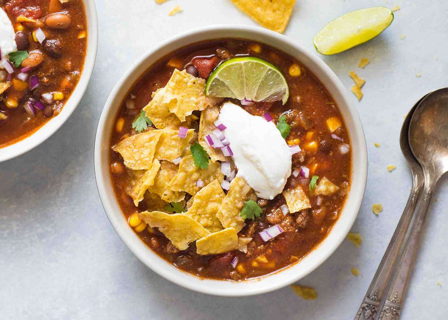 One bowl of slow cooker taco soup made with tomatoes, ground beef, corn, and canned beans.