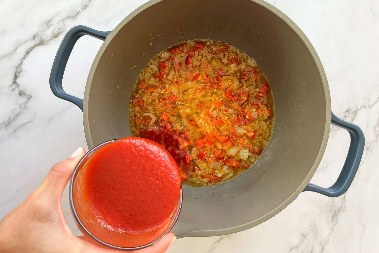Pulpeta (Cuban Meatloaf) braising liquid being made in a dutch oven.