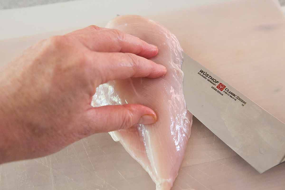 Chicken being cut in half horizontally