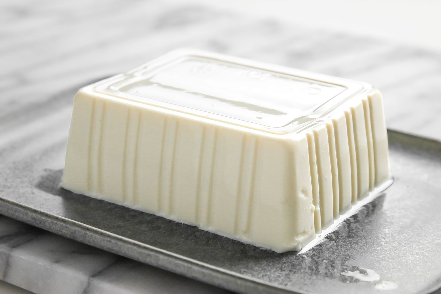 Block of Silken Tofu on a Platter for Silken Tofu with Sesame Soy Sauce Recipe