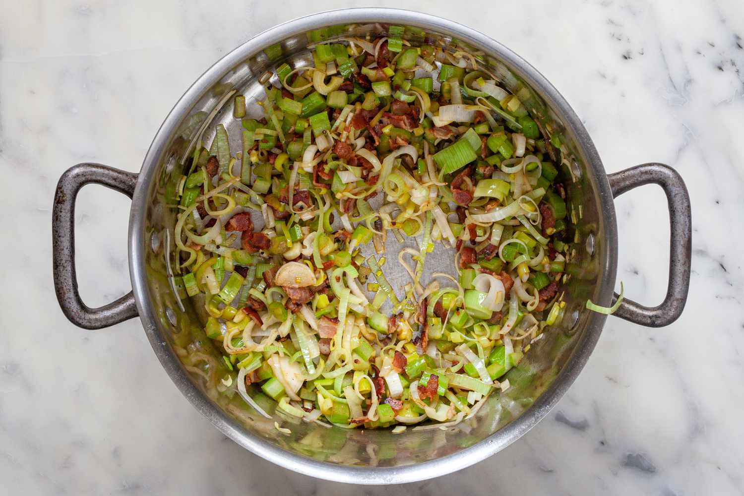 Leeks and Minced Celery Added to Pot and Lightly Sautéed with Bacon for Corn and Crab Chowder Recipe