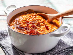 Baked Beans with Molasses - baked beans in a pot with a wooden spoon