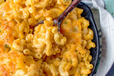 A close-up of a super-cheesy skillet of mac and cheese