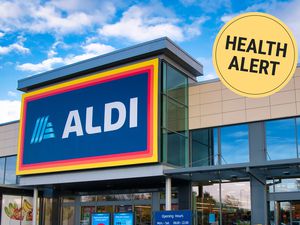 ALDI storefront with health alert tag