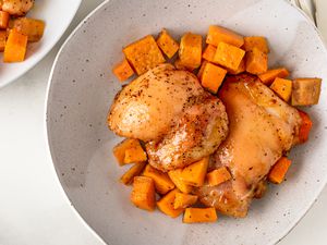 Overhead view of a bowl of roast chicken and sweet potatoes