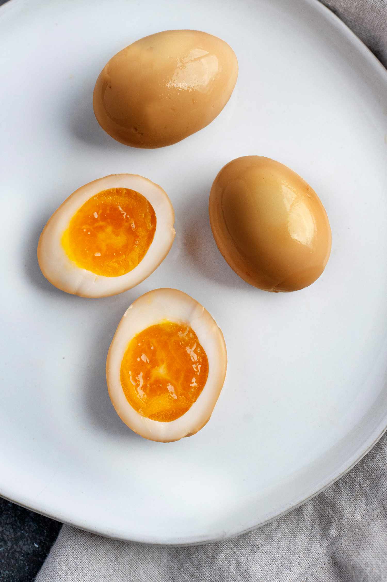 Soy Sauce Eggs on Plate with Two Eggs Cut in Half