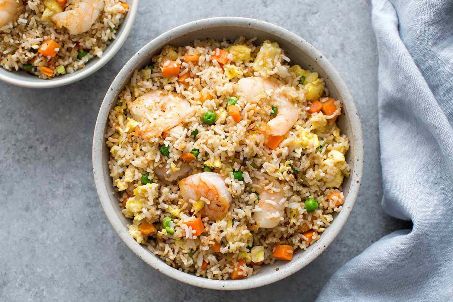 Overhead of two bowls of shrimp fried rice