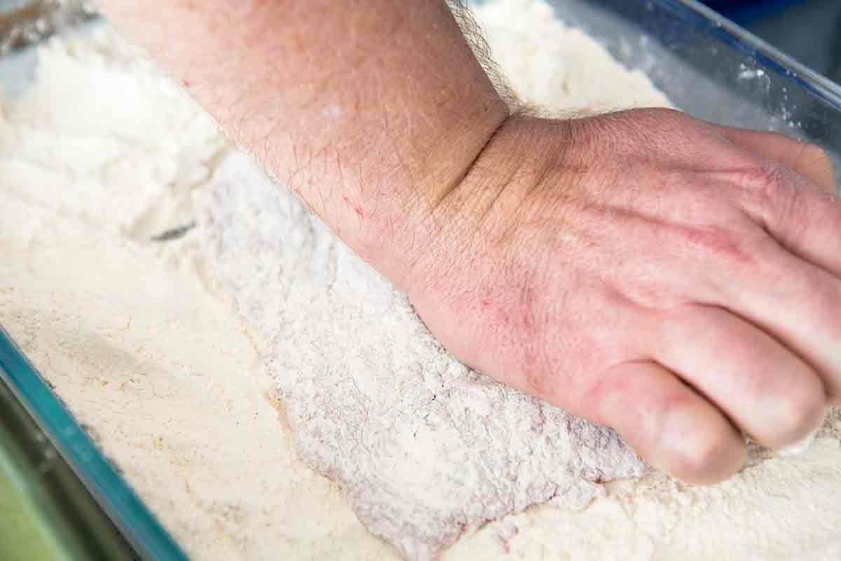 Rolling steak in flour