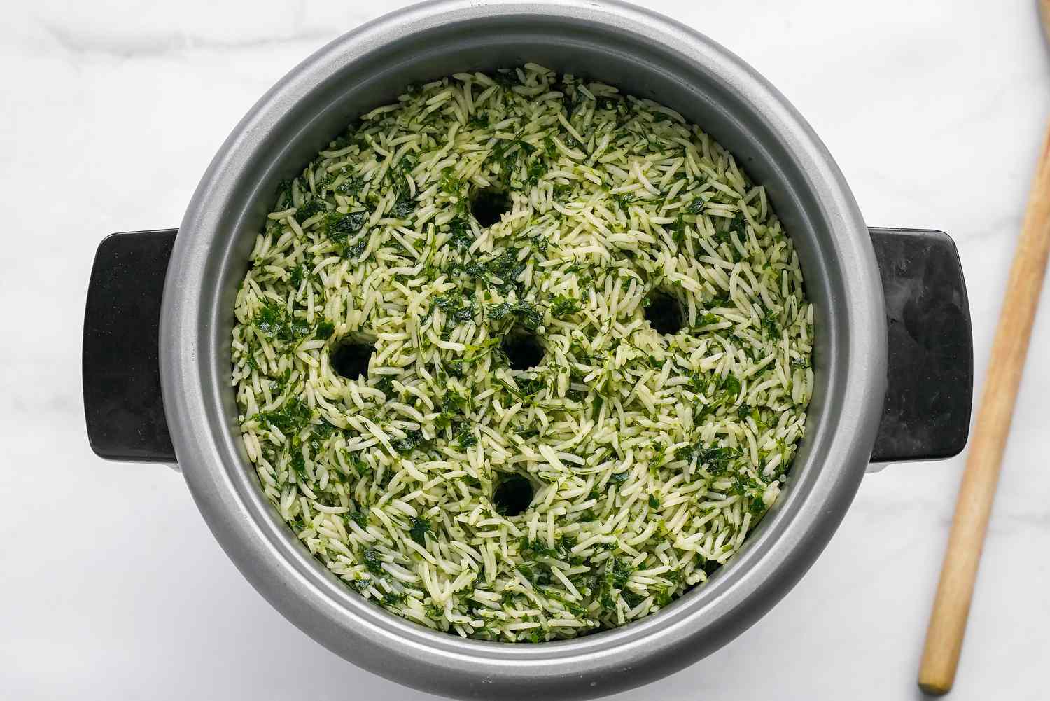 Holes Poked in Sabzi Polo (Persian Herb Rice) After Herbed Rice Layer Is Placed Over the Saffron Layer in the Pot