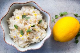 A bowl of Meyer lemon risotto with a Meyer lemon next to it