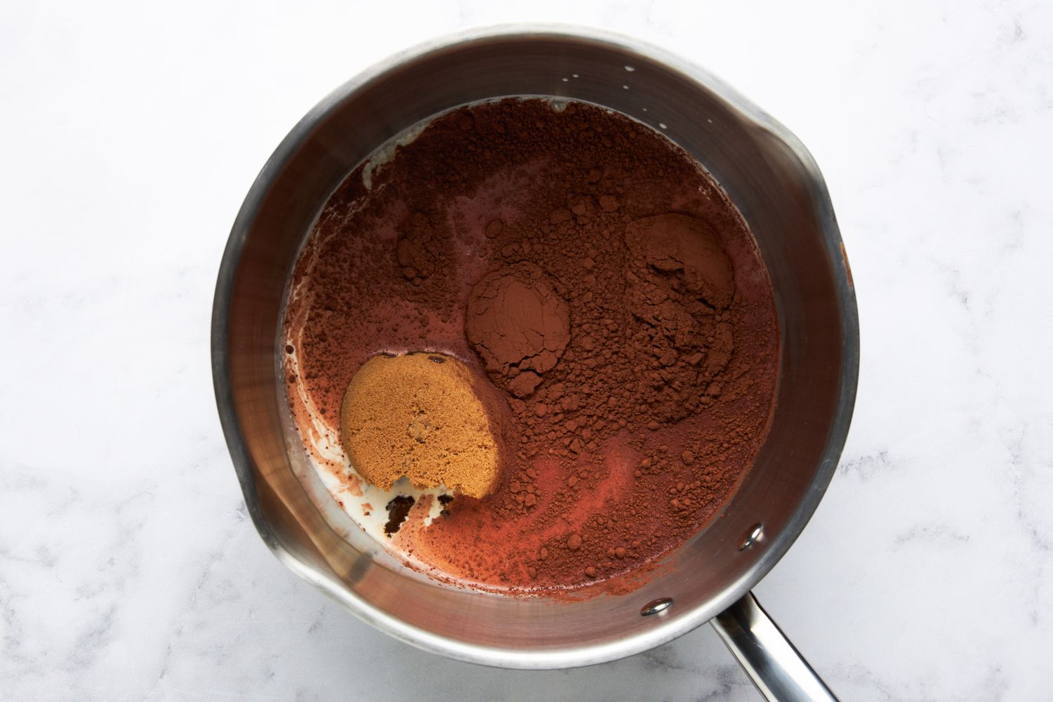 Cream, brown sugar, corn syrup, and cocoa into a saucepan for hot fudge sauce recipe
