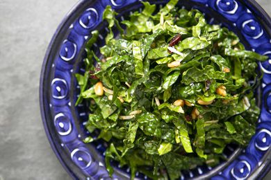 easy kale salad served in a blue bowl