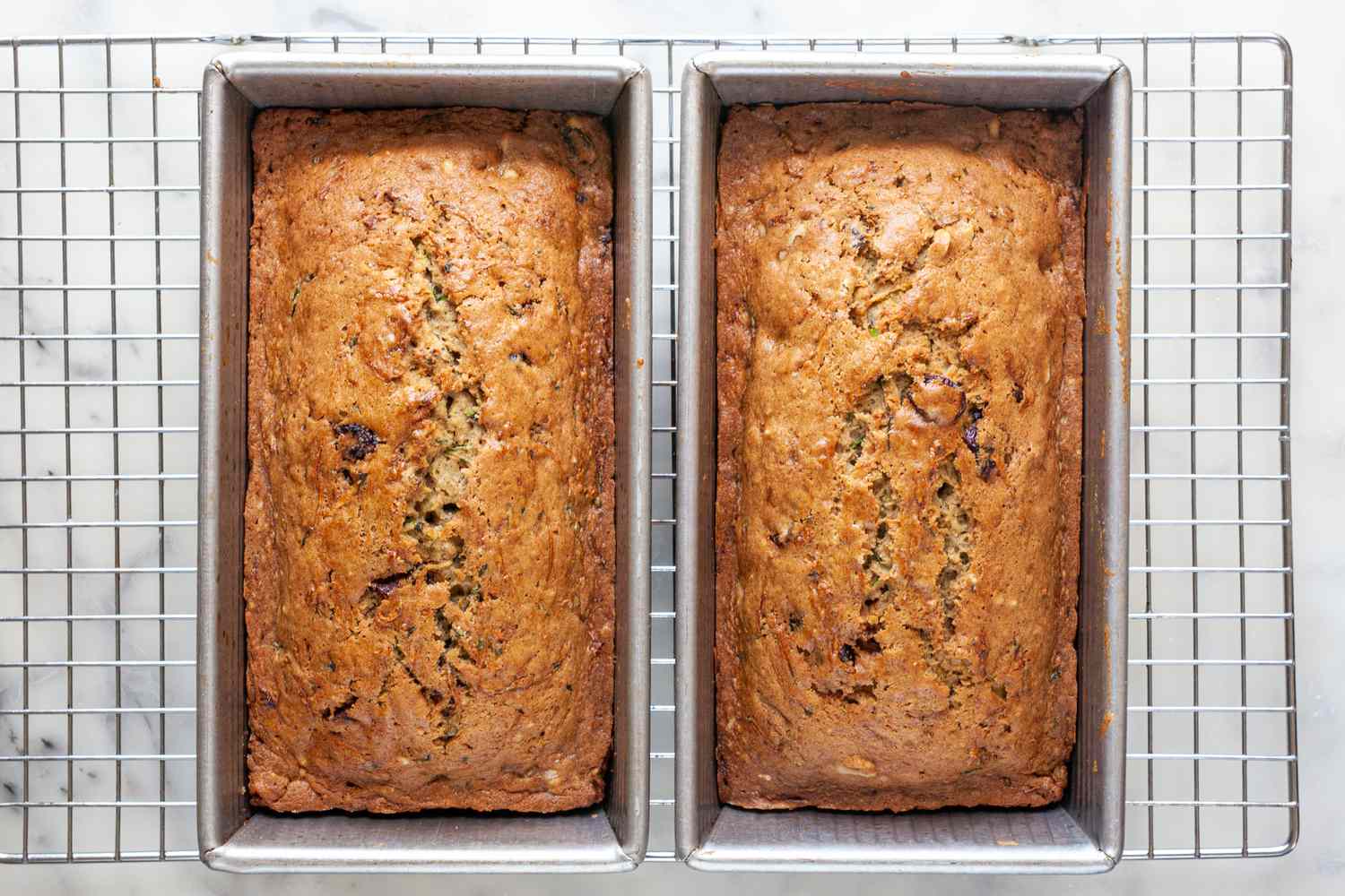 baked zucchini bread (in pans) cooling on a wire rack