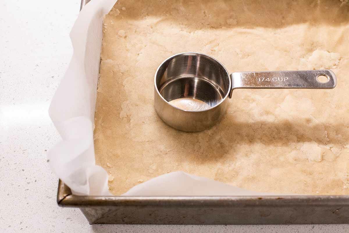 Best Ever Pecan Pie Bars press the crust into the pan