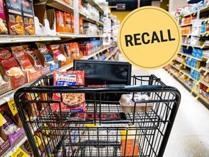 Looking down a supermarket aisle from behind a shopping cart.