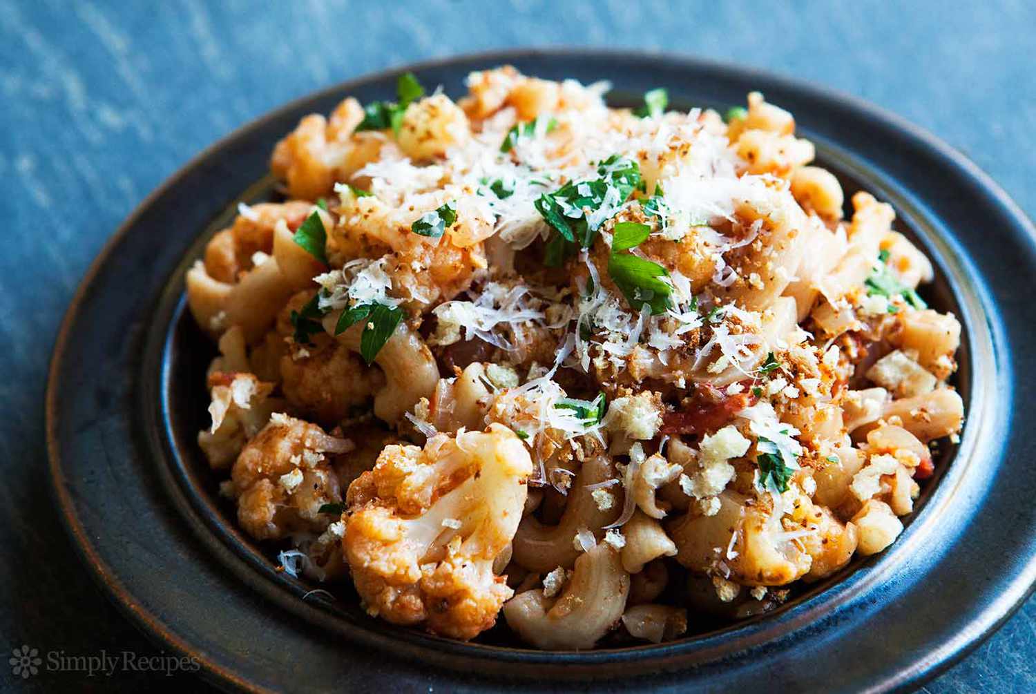 A bowl of Pasta with Cauliflower Tomato and Parmesan