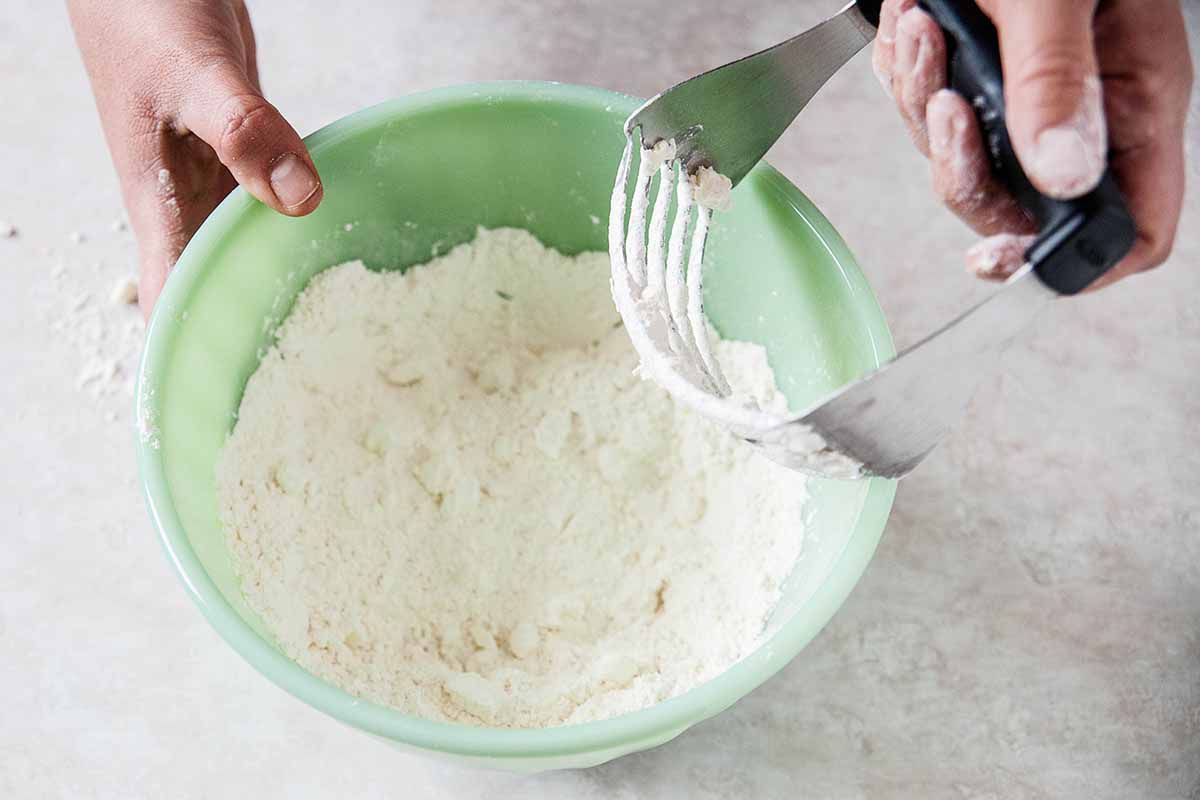 Southern buttermilk biscuits - green bowl with flour and pastry cutter