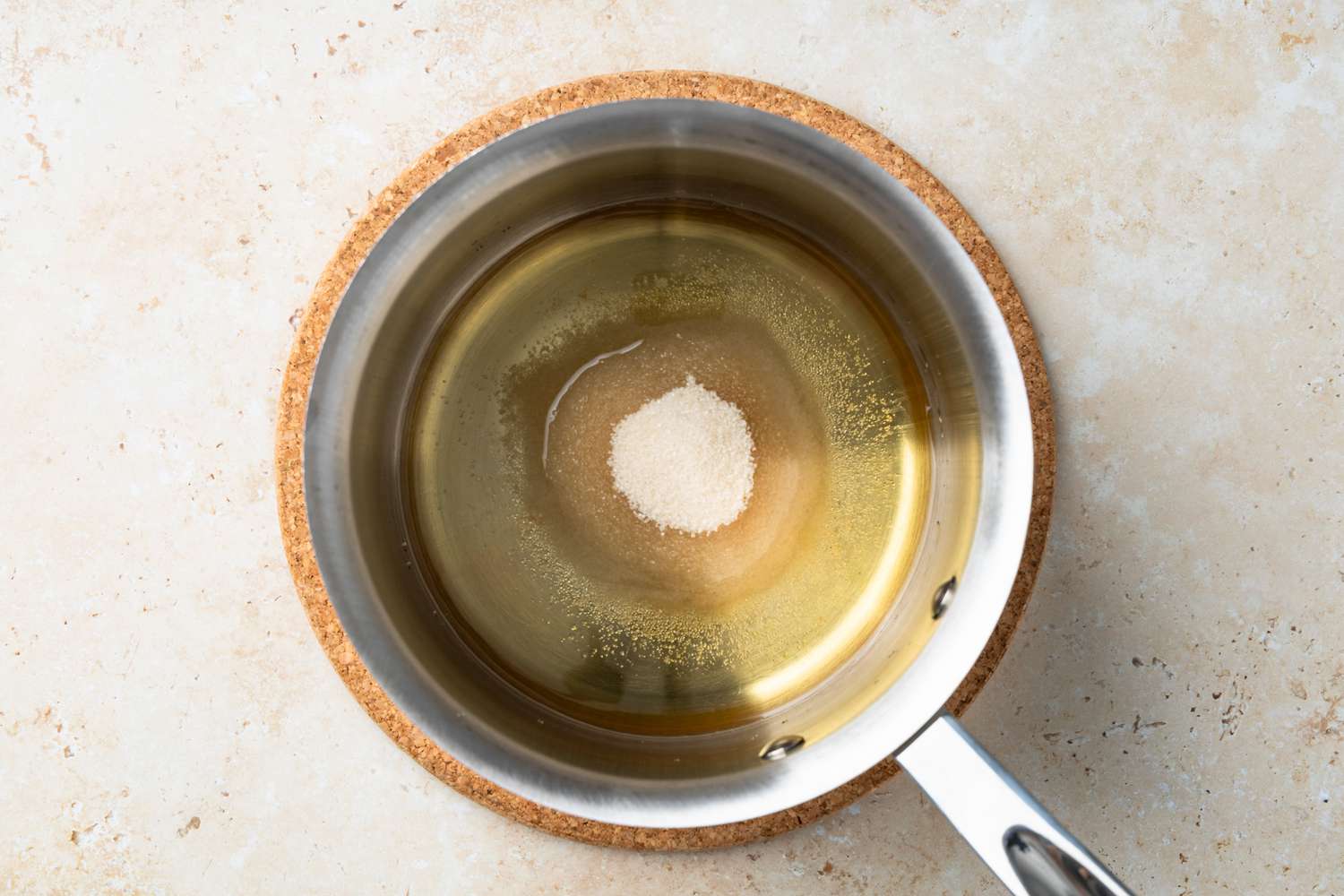 Pot of Water, Sugar, and Dark Rum for Almond Croissants Recipe