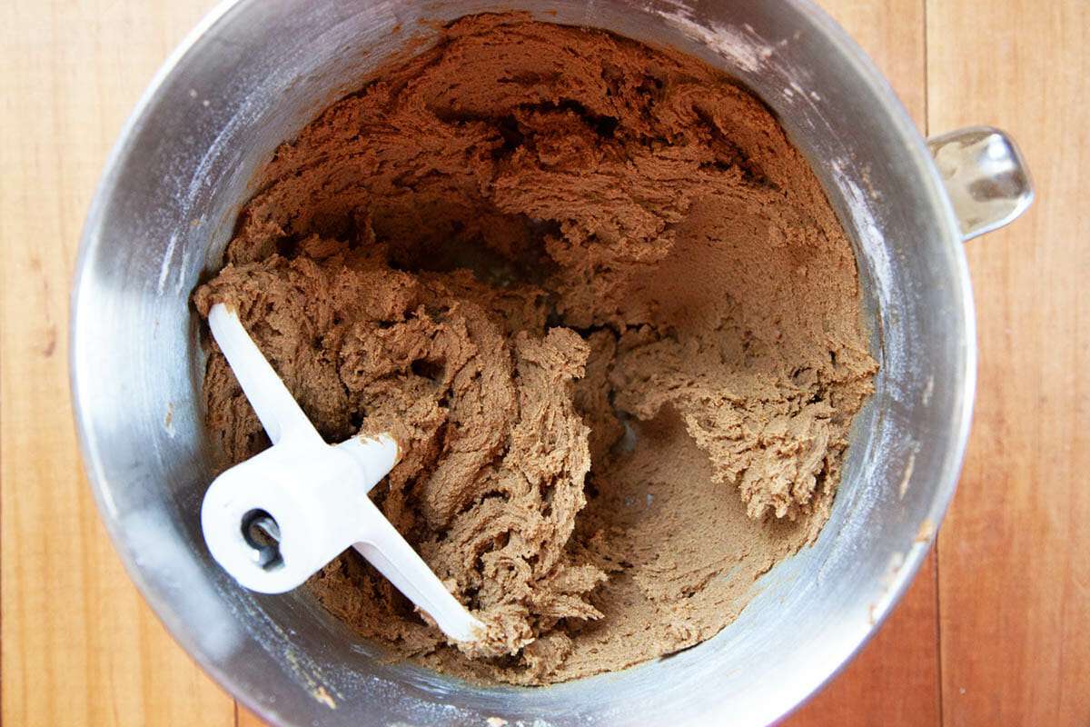 Batter for the Best Gingerbread Bars is mixed in a metal bowl with the paddle attachment inside.